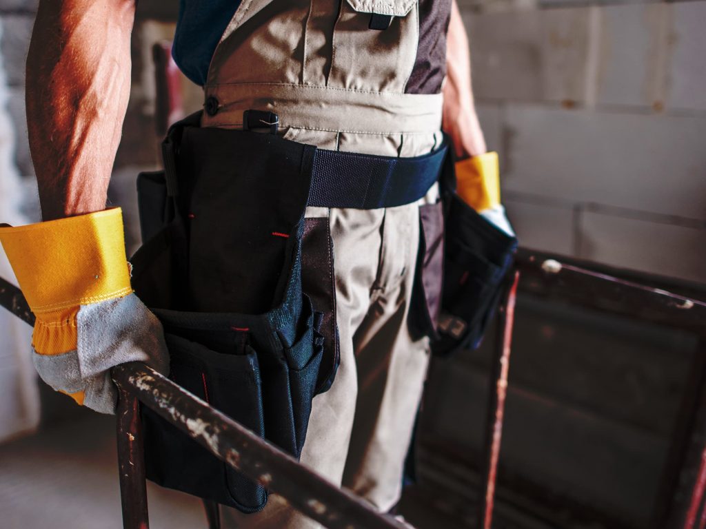 Scaffolder carrying tube on site